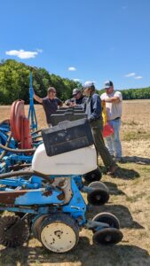 Researchers around a planter